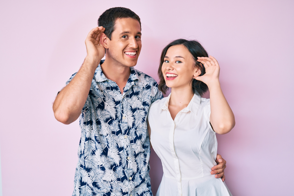 husband and wife with hearing loss against lavender background