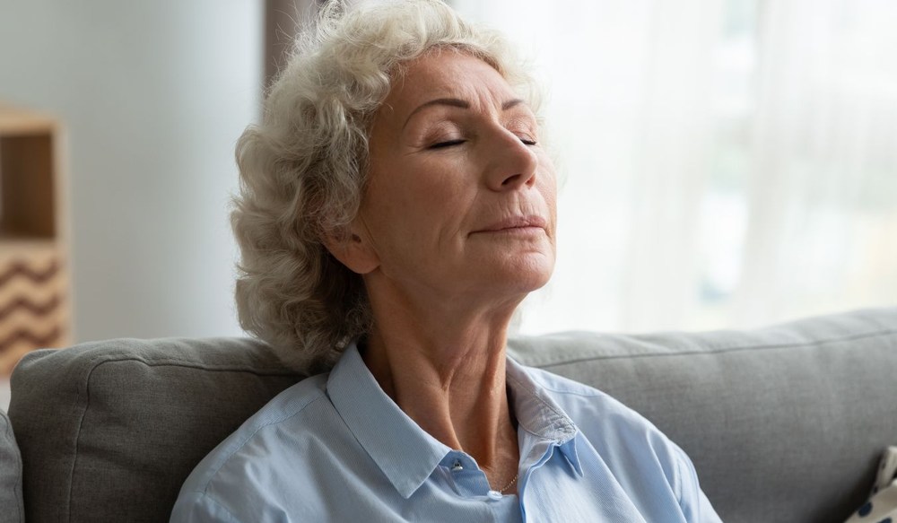 tinnitus senior woman sitting quietly