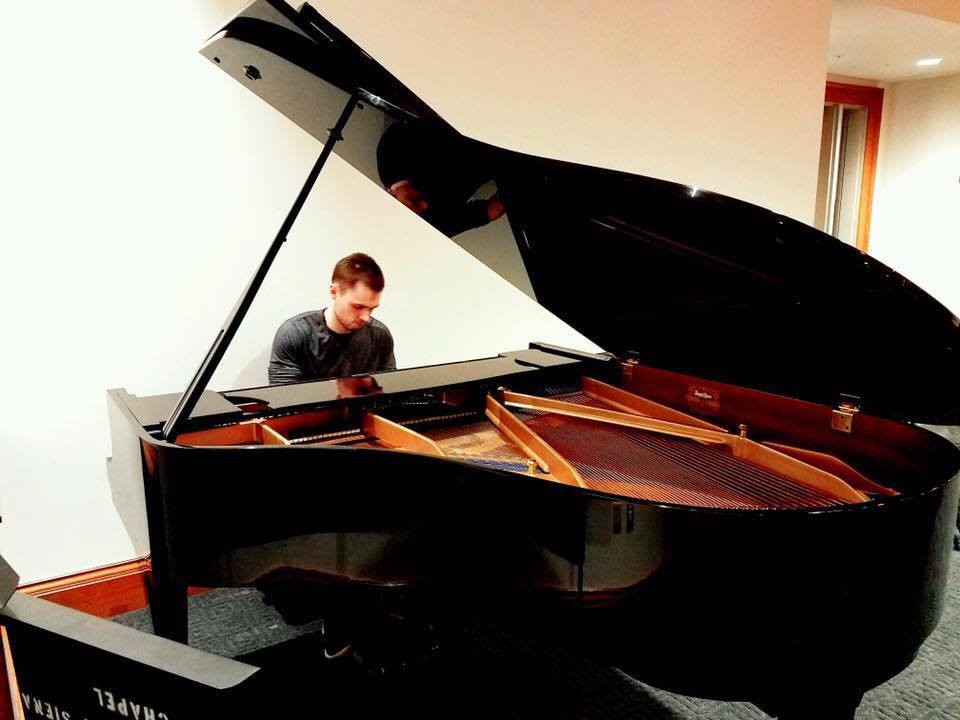 Micah as a strapping young man playing piano.