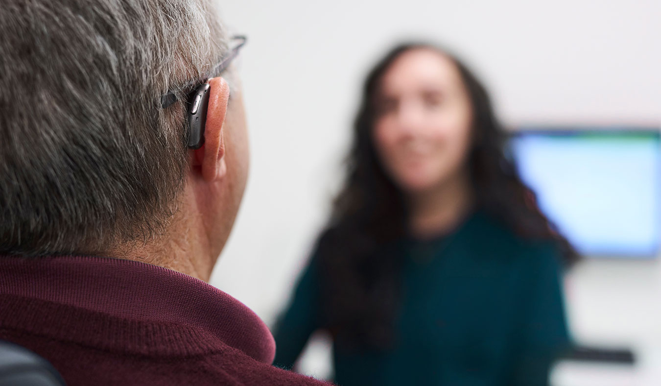 closeup of hearing aid on mans ear