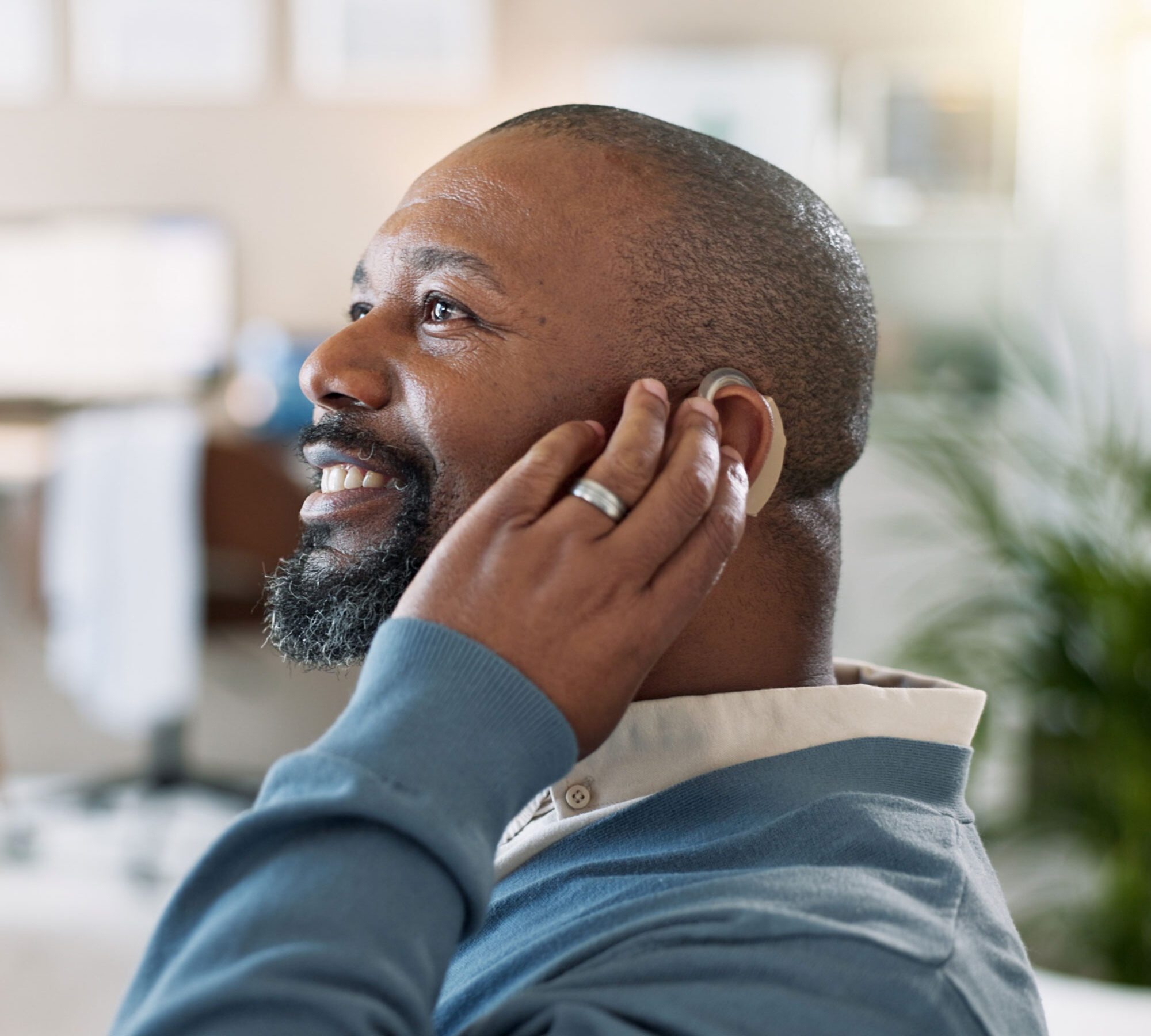 man trying on hearing aid
