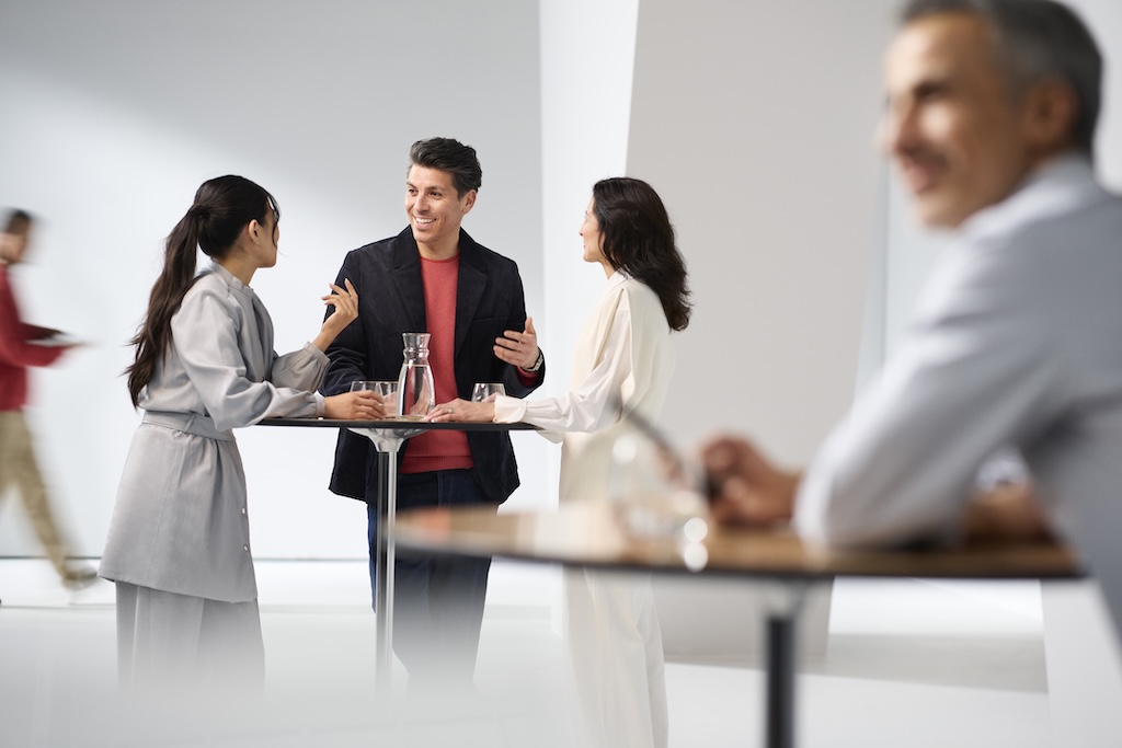 Three people talking and laughing together at a table