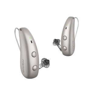 RS NX Dinner Listen 2653 Pair of sleek beige behind-the-ear hearing aids with open eartips and small LED indicators on.