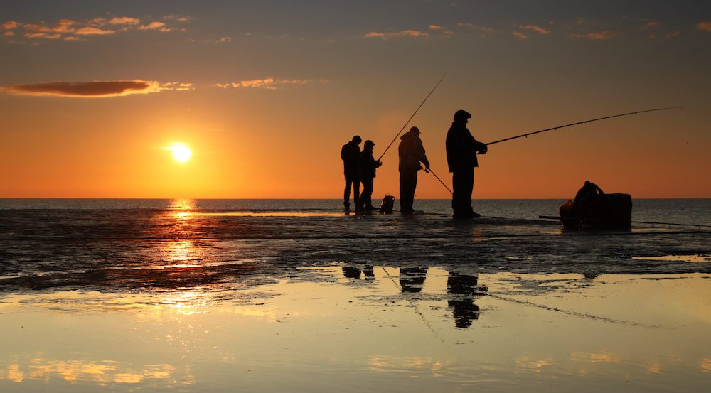 family fishing at a beach