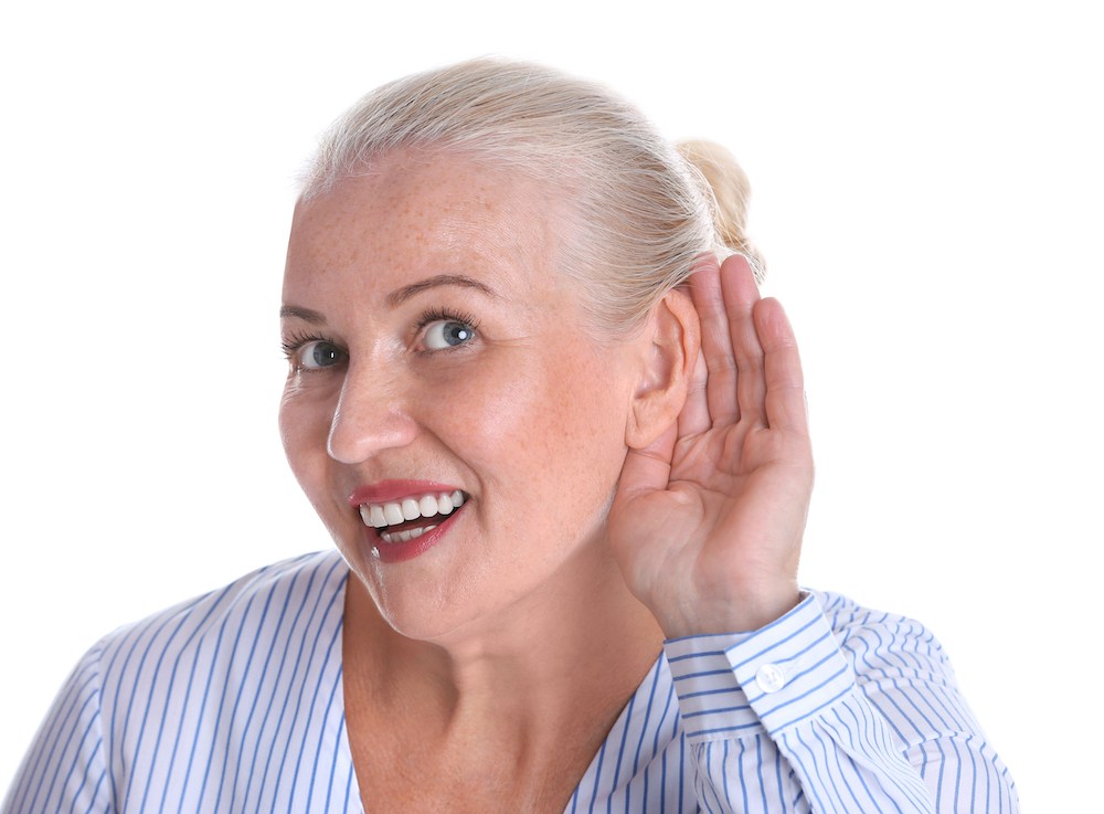 smiling hearing loss patient struggling to hear properly