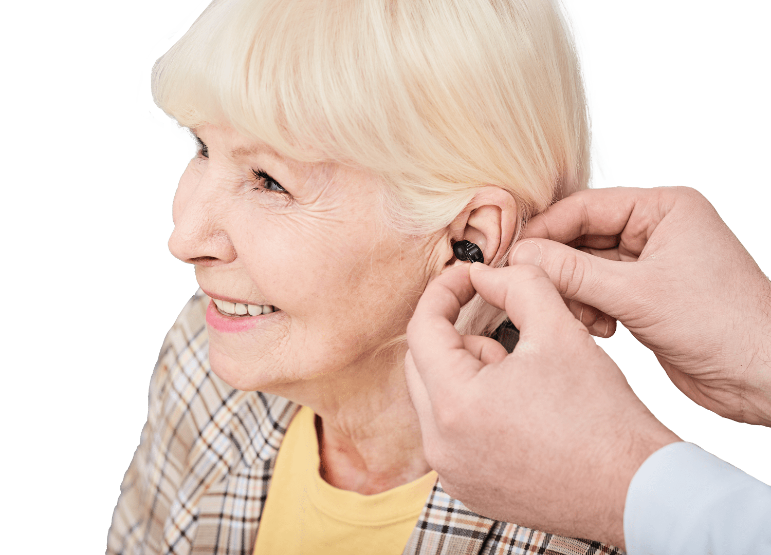 provider playing hearing aid in older woman's ear for try on