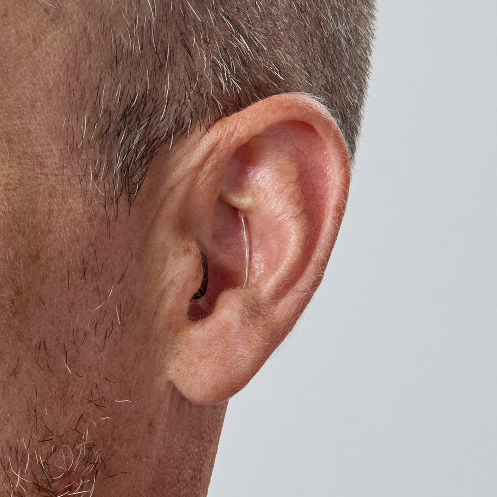 oticon zeal nxtCIC close up in ear on senior man