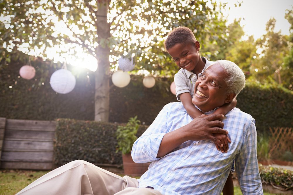 grandfather playing outside with his grandson