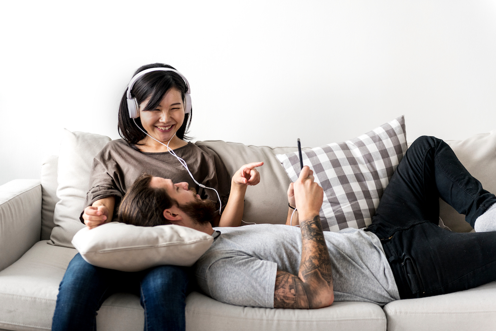 couple listening to music with earbuds