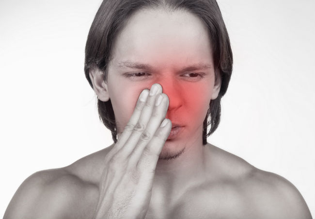 blowing nose while blocking one nostril