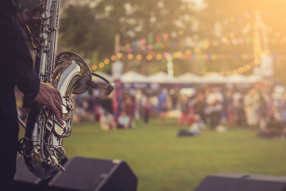 saxophone playing music at an outdoors concert venue
