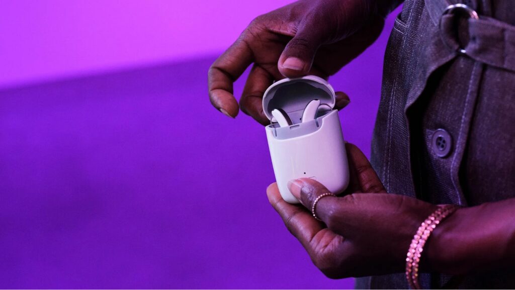 signia styletto ax lifestyle in charger closeup in hand