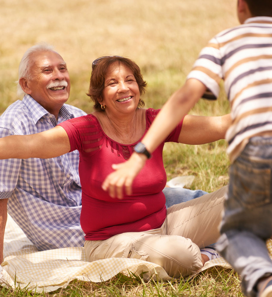 grandparents having picnic with grandson outside