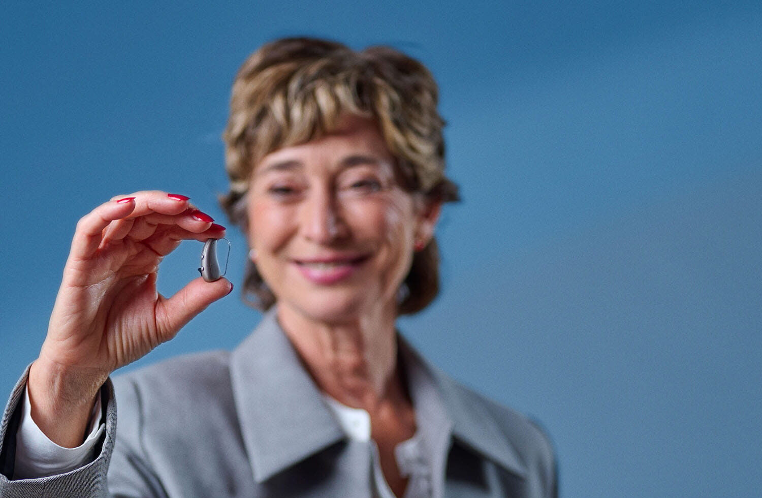 signia pure charge&go ix lifestyle woman holding hearing aid
