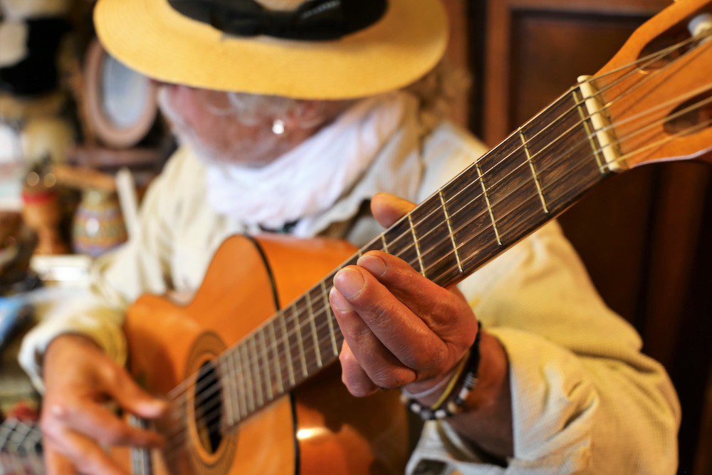 closeup of man playing a guitar