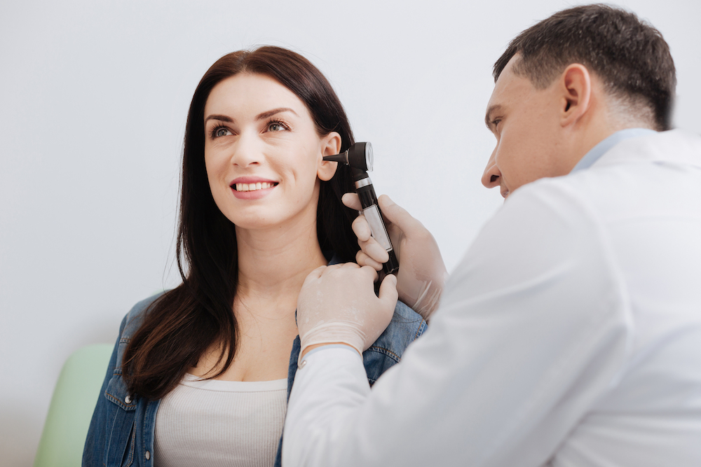 woman sitting for hearing evaluation