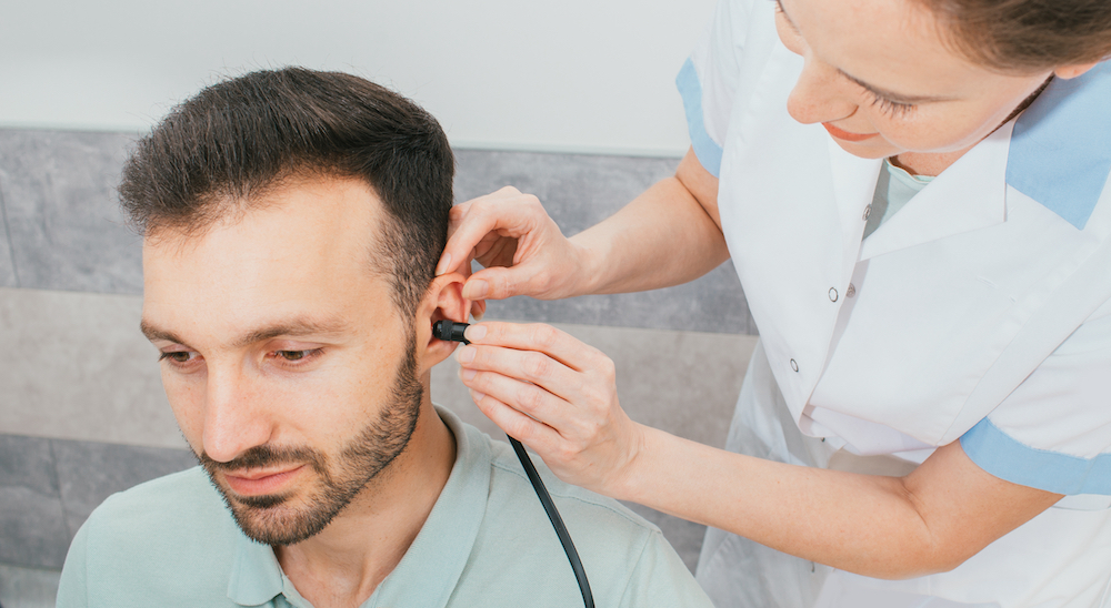 younger man having a hearing evaluation