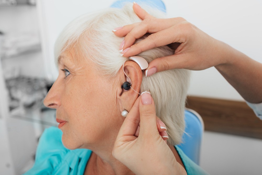 side angle of hearing loss patient during a hearing aid fitting appointment optimized