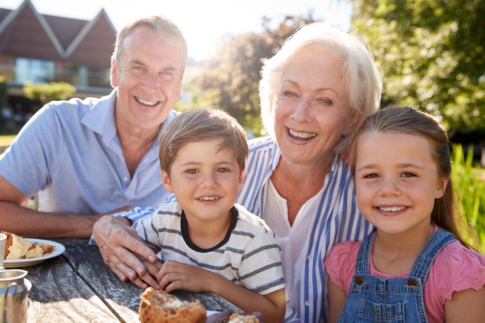 a family picture outside on a lawn