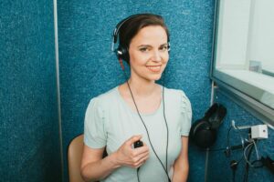 Audiometer hearing test. Adult beautiful woman getting a hearing test at the special audio room