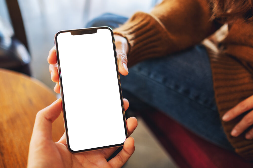 Mockup image of a woman holding and showing white mobile phone w
