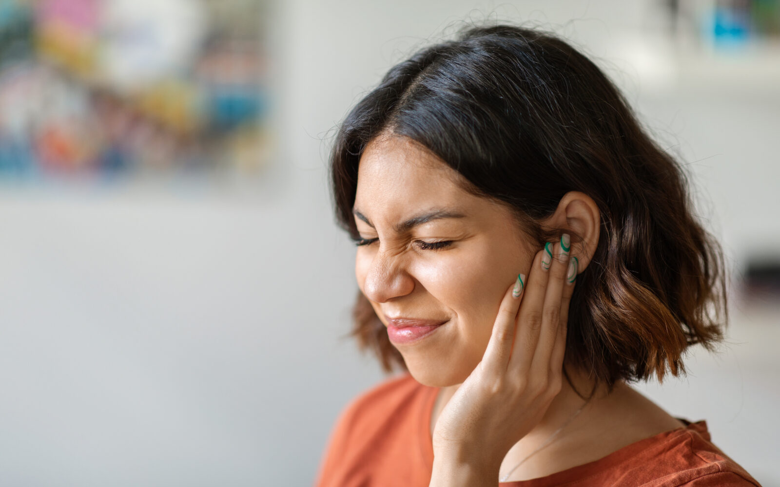 Sick young arab woman having ear pain at home