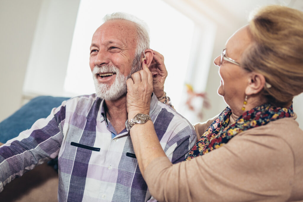 Older man and woman or pensioners with a hearing problem