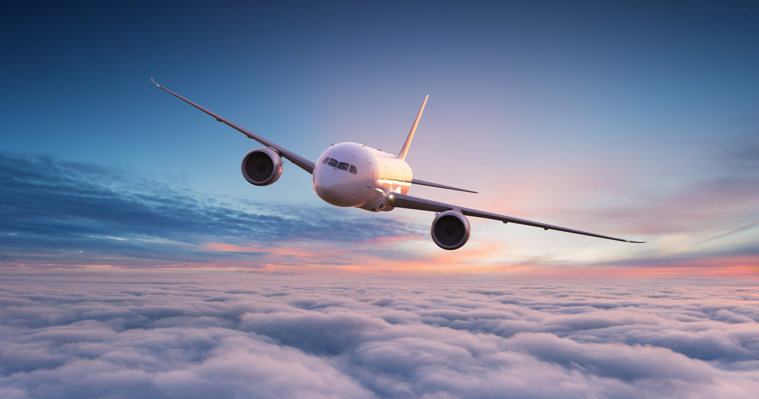 Commercial airplane jetliner flying above dramatic clouds