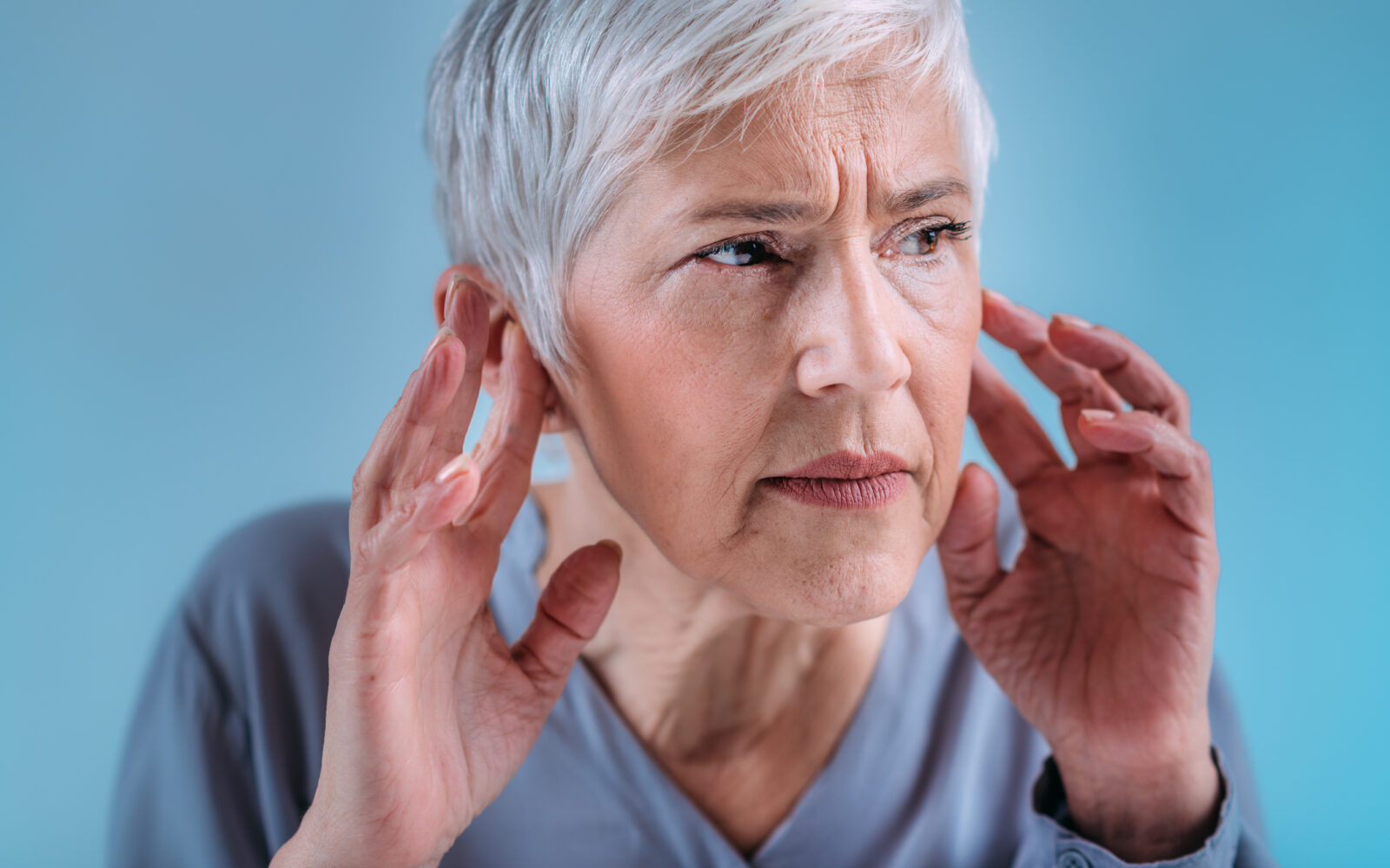 Hearing Loss Senior Woman with Symptoms of Hearing Loss