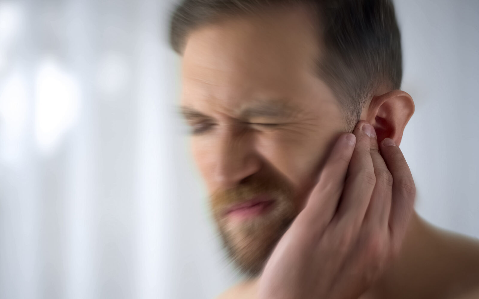 Man feels pain in middle ear, meningitis and hearing loss, inflammation, closeup