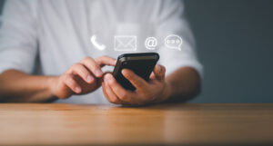 Customer support hotline Contact us people connection Businessman using Smart Phone with the email, call phone, address, Chat message icons