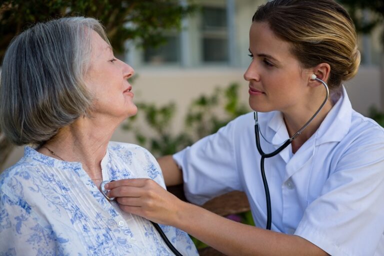 woman testing the heart beat of a patient