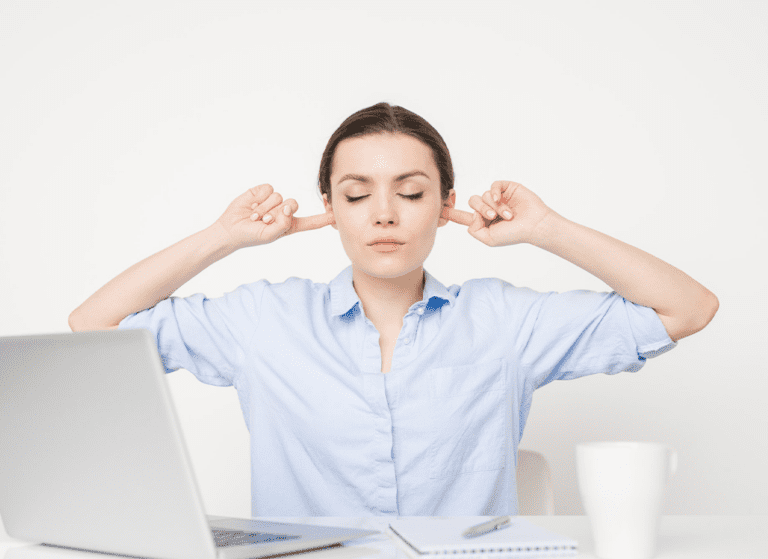 woman putting fingers in her ear