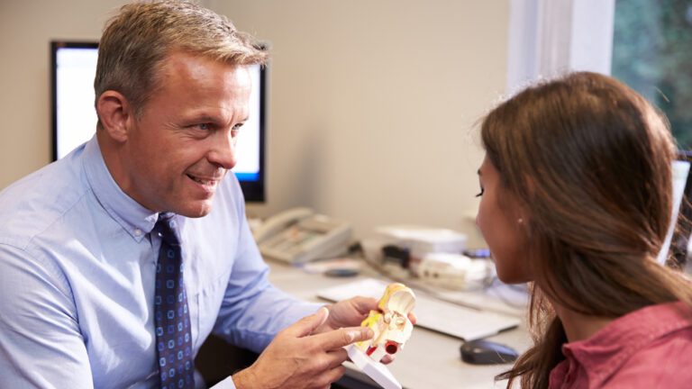 hearing specialist discussing hearing aids with his patient