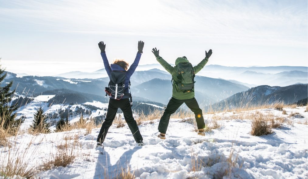celebrating hikers snowy mountain