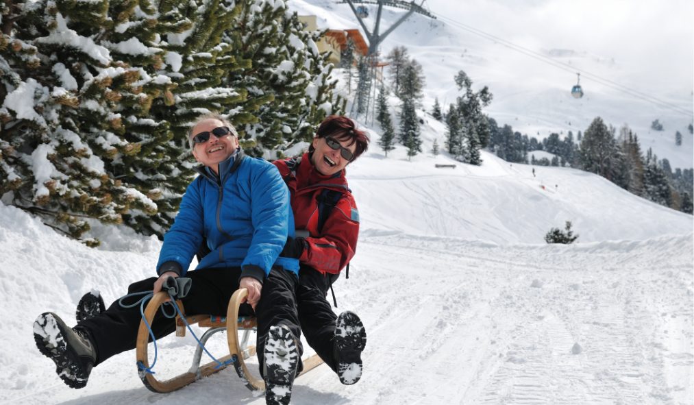 winter mature couple bobsledding
