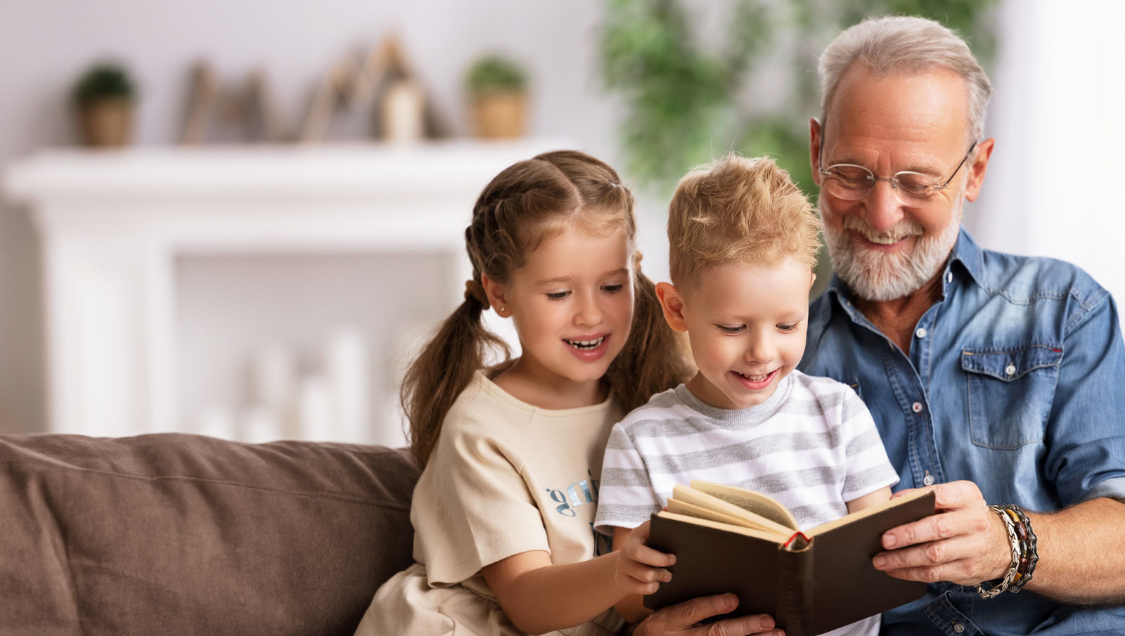 grandfather reading to grandchildren