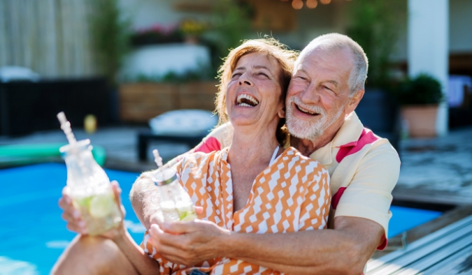 event image mature white couple pool party laughing