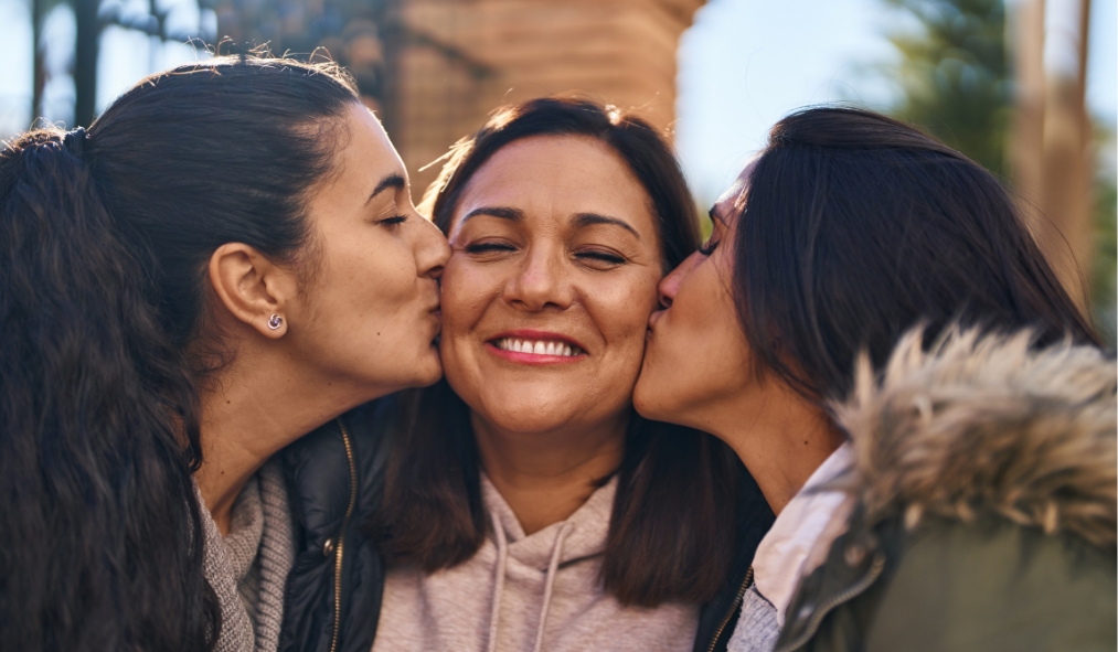 winter mother daughters kiss