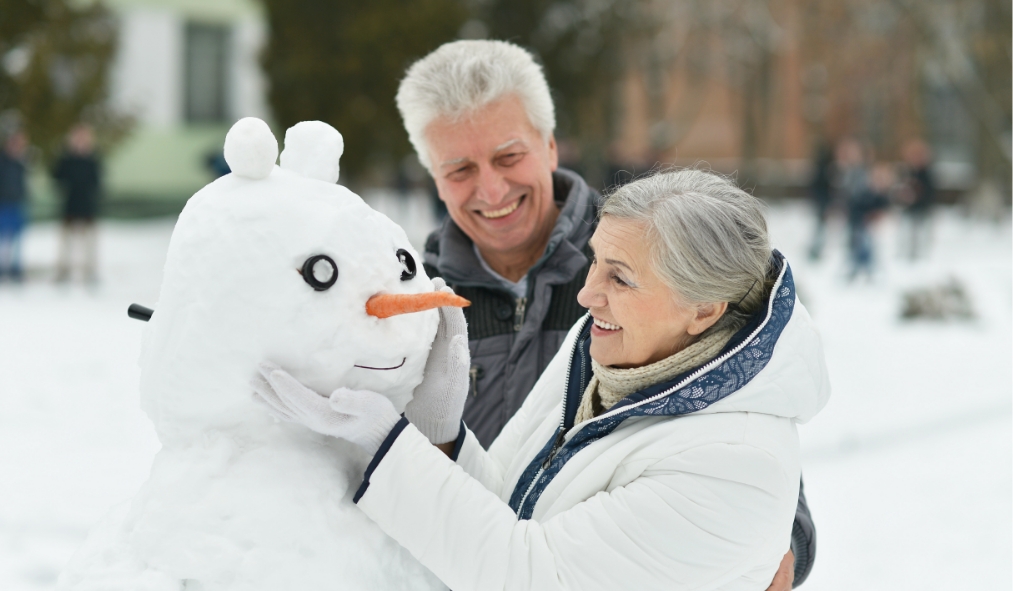 winter senior couple snowman