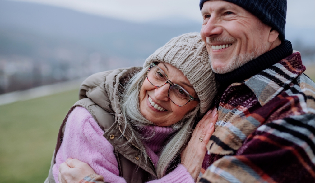 events winter mature couple outside hugging smiling