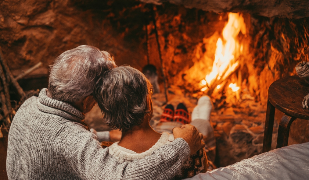 events winter mature couple cozy by fireplace