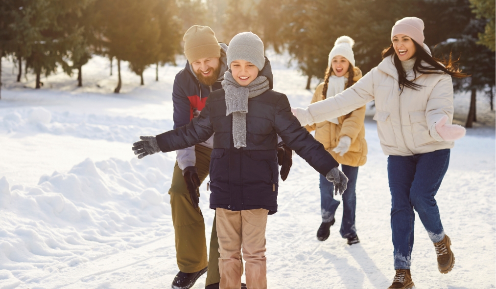 winter family playing in snow