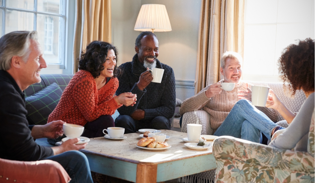 winter diverse group of friends enjoying tea laughing