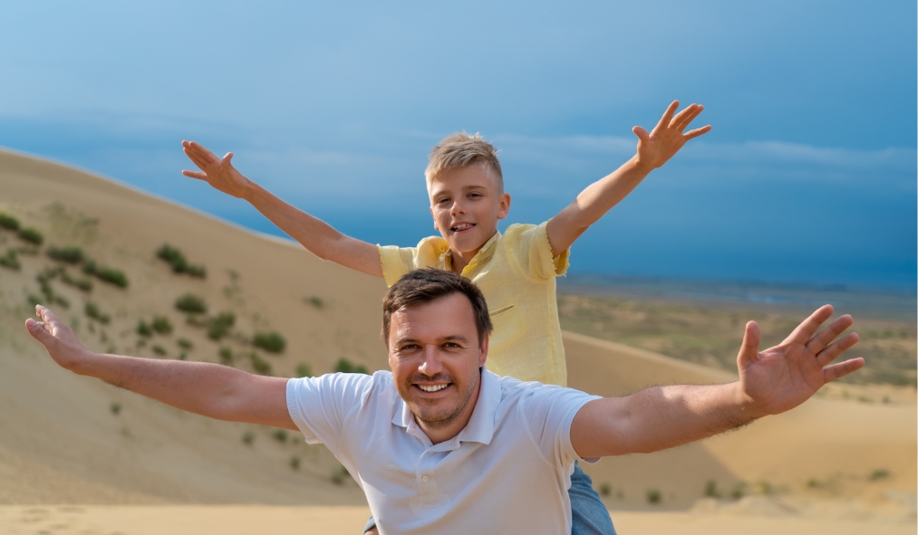 nevada sand dunes father son playing in sand