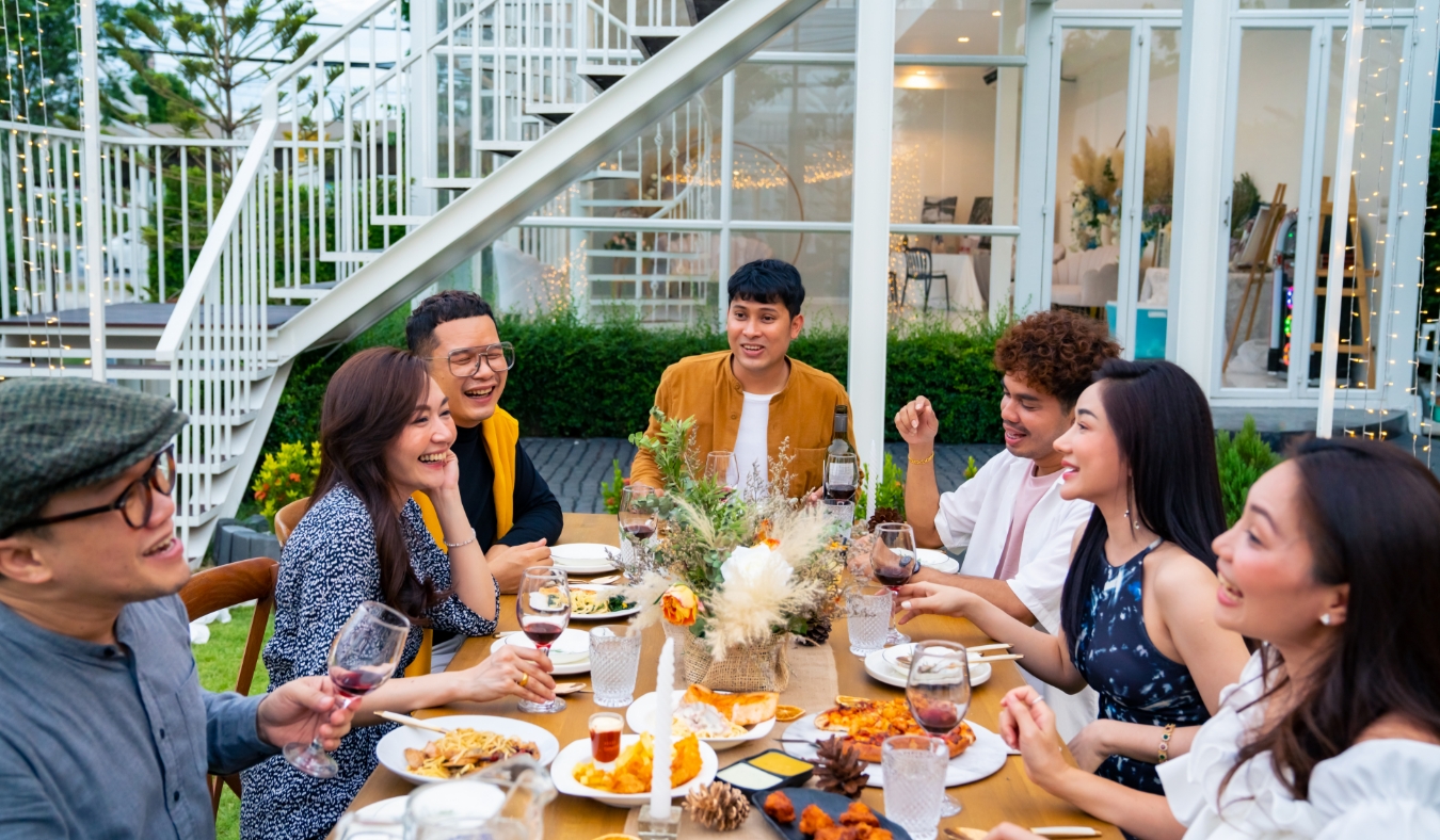 Asian people friends enjoy outdoor garden dinner party eating food