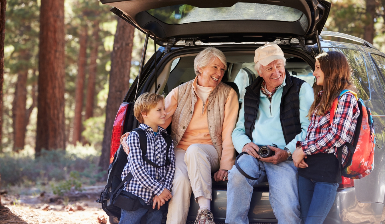 Grandparents and grandkids at the back of car before hiking