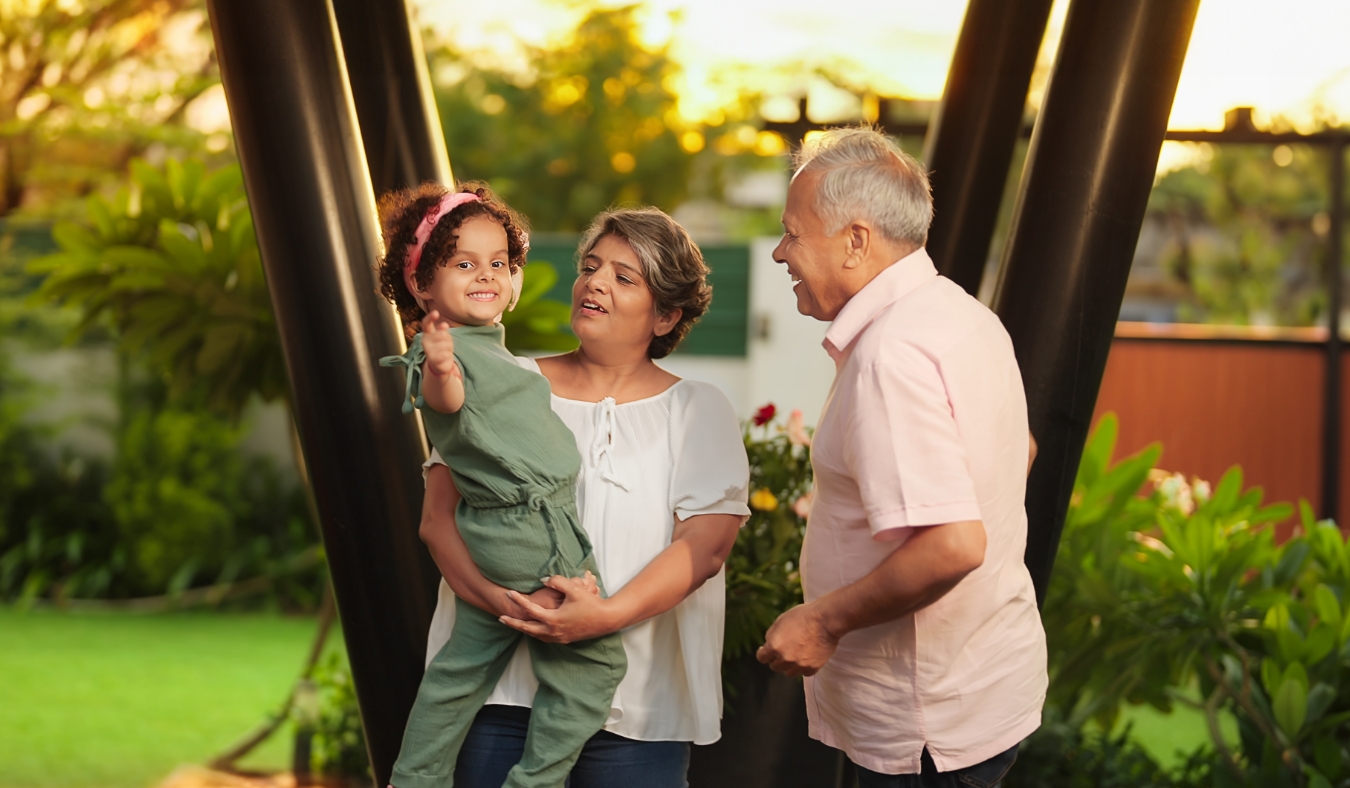 indian grandparents holding granddaughter