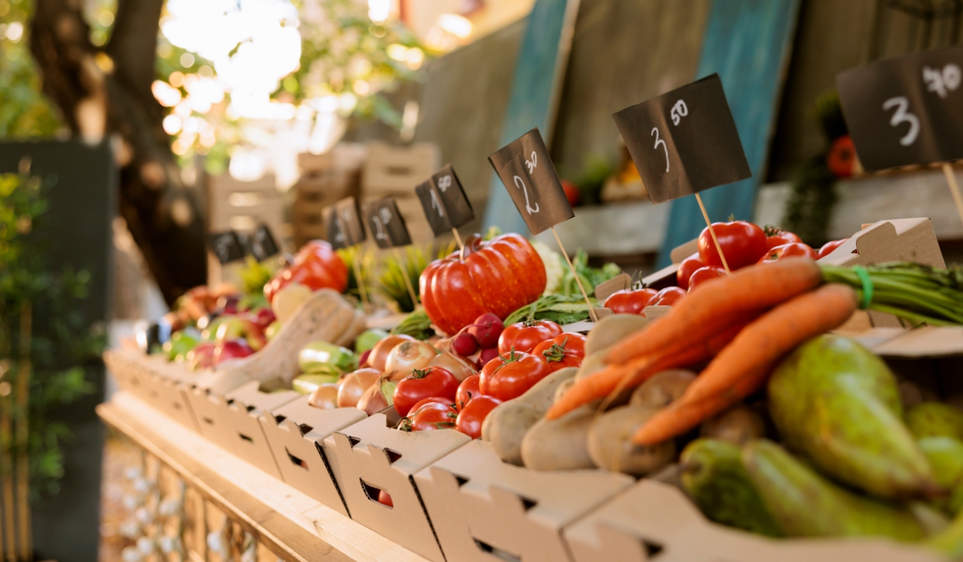 locally grown colorful fruits and vegetables at farmers market booth