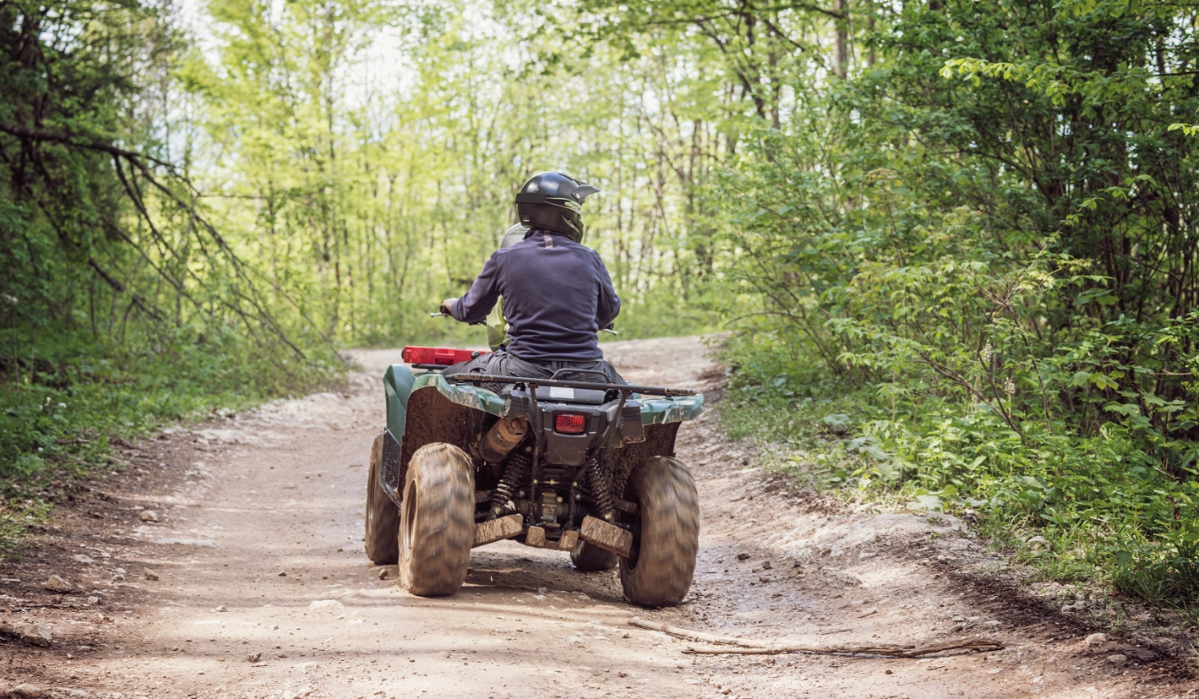 Man on the ATV Quad Bike on the mountains road